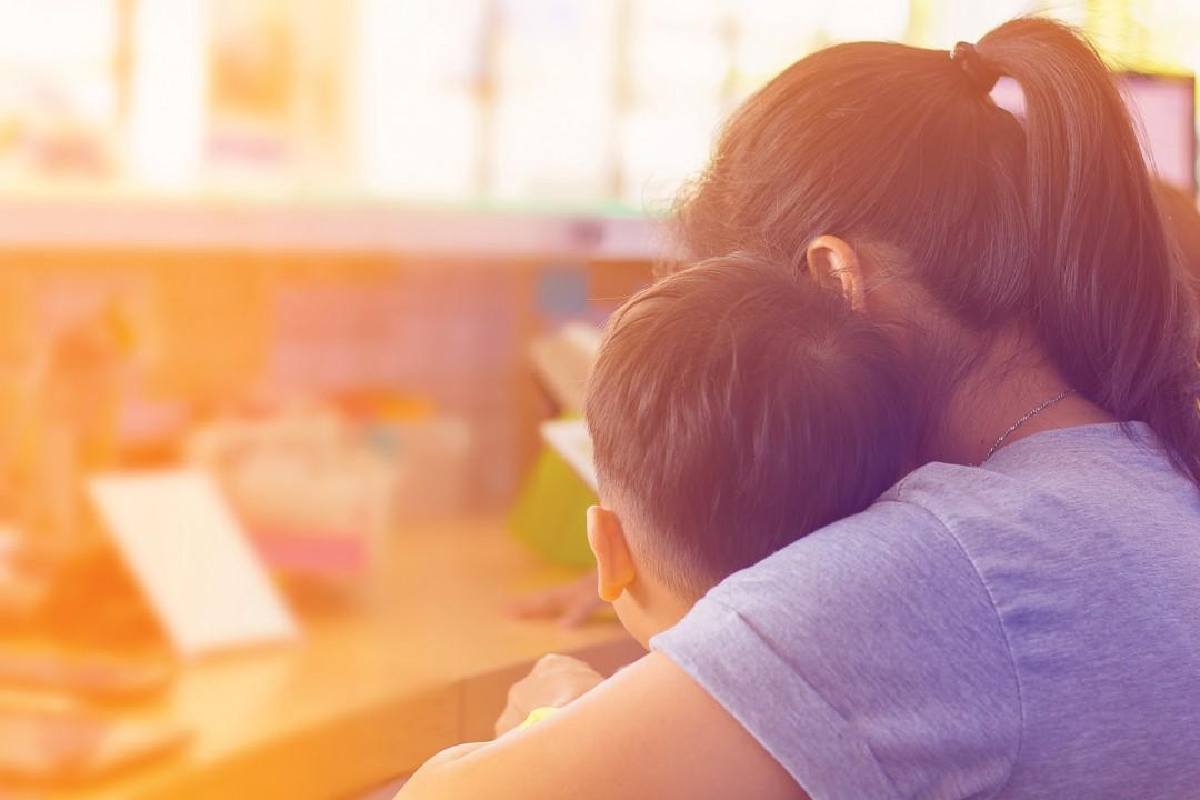 image of child learning from teacher or caregiver